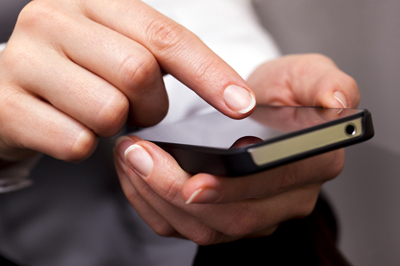 A doctor holding a cell phone.