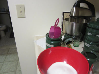 Sugar jar with measuring cup stuck in the opening.