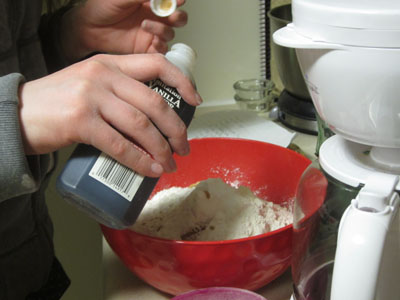 User pouring vanilla extract straight into bowl.