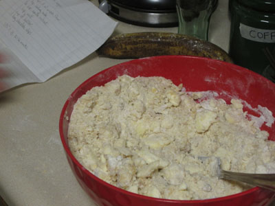 Plastic bowl full of half mixed cookie dough.