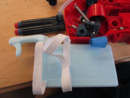 Foam model next to a plastic trigger mechanism from an already existing toy.